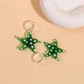 Detailed view of green glass starfish pendants with white polka dots and clear glass hooks - Green