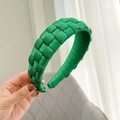 Detailed view of handmade green woven fabric headband with smooth satin texture - Green