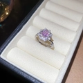 Macro shot of square pink gemstone ring with halo diamonds and twisted pavé band - Flower Style / Silver-Pink