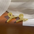 Translucent jelly yellow mini claw clip with twist design on dark wood background - 1 Piece / Jelly Green