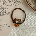 Detail of tortoiseshell acetate flower hair tie with pearl center and brown elastic band - Lake Blue Coffee