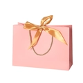 Elegant pink paper gift bag featuring a golden ribbon bow and durable braided handles - Pink; Horizontal Extra Small Size 19*15*7 Ribbon Style