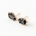 Macro shot of 14k gold-plated pear-shaped zircon earrings with meticulous claw setting details - Dark Grey