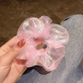 Iridescent pink organza scrunchie with holographic mermaid laser glow held by hand - Mermaid Pink