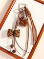 Brown leopard print bow keychain with heart pendant and woven ropes on white background - Bowknot Style