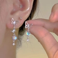 Macro view of silver butterfly earrings with iridescent beads on a female model - Silver Butterfly Magic Color Bead Earrings (1352)
