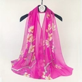 Elegant rose red chiffon scarf featuring a cream magnolia floral print on a hanger - Rose Red Magnolia