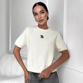 Slim fit white knit short sleeve top with a crew neck and a small black chest graphic - S / White