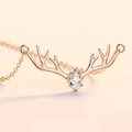 Macro shot of rose gold reindeer antler necklace with a teardrop zircon pendant detail - Adjustable Open / Deer Antler Open Style / Rose Gold