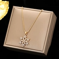 Golden snowflake pendant necklace with sparkling crystals displayed on a premium jewelry box - Necklace / Gold