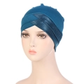 Détail du turban turquoise élastique montrant le plissé croisé et la texture tricotée - Bleu lac