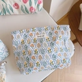 Detailed close-up of floral cotton makeup bag with simple wish label and soft texture - Blue Rhombus Floral Branch
