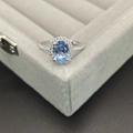 Classic 925 sterling silver ring featuring an oval blue gemstone on a gray velvet tray - Size 5 / Topaz