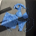 Detailed flat lay of blue wave print bikini set with matching sarong and headband - S / Blue