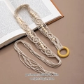 Detail of bohemian hand-woven cotton belt with wooden beads on an open book - White Woven Round Buckle Belt (X492-3)