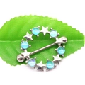 Macro shot of silver stainless steel nipple ring with blue opal stones and stars on a leaf - Blue Opal Star Style