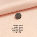 Black 8mm cylindrical stainless steel spacer bead with hole on pink satin background - Black