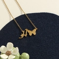 Gold stainless steel initial H necklace featuring a butterfly charm and dainty cross chain - Gold H