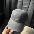 Close-up of washed cotton baseball cap featuring embroidered logo and reinforced stitching - Pink