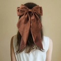 Elegant large brown satin bow hair clip with long ribbons worn on the back of the head - Bronze