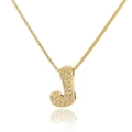 Macro detail of gold-plated letter J pendant with sparkling pave-set cubic zirconia crystals - Letter J