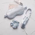 Three-piece faux silk sleep set in ice blue featuring eye mask, headband, and scrunchie - Mercerized Blue