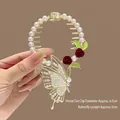 Hair clip with red roses, hollow butterfly and pearls on golden base, diameter 6.5cm - J51 Cherry Butterfly Ponytail Buckle