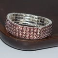 Exaggerated four-row stretch bracelet featuring purple rhinestones on a silver base - 4 Row Silver Purple Rhinestone Bracelet