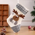 Beige and grey Christmas stocking featuring reindeer and snowflake decor on wooden desk - Reindeer