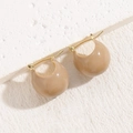 Elegant caramel brown resin heart earrings with gold-toned metal clasp on stone background - Round Light Coffee