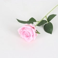 Pink artificial velvet rose with green stem and leaves on a clean light background - Silk Cloth Rose / Silk Pink