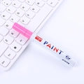 GuangNa M101 white oil paint marker with pink cap 2.8mm tip on a white keyboard - Rose Red
