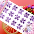 Detail von lila Kleeblatt-Kristallaufklebern auf pinkem Hintergrund für DIY-Dekoration - Schmetterling Lila