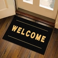 Zerbino rettangolare nero Welcome con scritte dorate su pavimento in legno - Benvenuto Stile 3 / 40*60cm