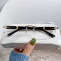 Frameless rimless sunglasses with clear lenses and golden metal temples on a leather case - Gold Frame White Lens Black Temple