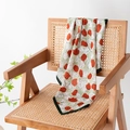 Vintage green silk scarf with red tulip prints draped on a classic rattan armchair - Green Rose