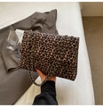 Large leopard print tote bag with golden metal chain strap held in a lifestyle setting - Leopard Chain Bag / Brown