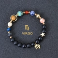 Detail of Virgo constellation planet bracelet with black matte beads and gold charm - Virgo
