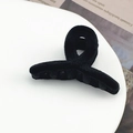 Close-up of black flocked hair clip with twisted design and serrated grip on white surface - 2# Ribbon Black