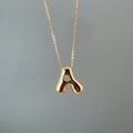 Detailed view of polished golden letter A pendant on a delicate link chain necklace - Letter A Single Pendant