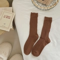 Women's dark brown cotton ribbed knit mid-calf socks in cozy lifestyle setting - One Size / Coffee