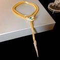 Detailed macro view of the gold serpent necklace with green gemstone eyes and pavé crystals - 41# Necklace - Gold - Snake Rhinestone Green Eye