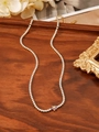 Detail view of a gold floral tennis necklace with purple petals on a wooden tray - Purple Flower Style (ZHN351-Purple)
