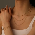 Three-layer gold beaded titanium steel necklace and bracelet set worn by a model - Gold Necklace Bracelet Set