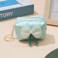Detail of mint green quilted coin purse with pearl bow and golden keychain clip - Emerald Green