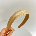 Detailed view of gold padded headband with vintage pleated faux leather texture - Gold