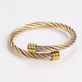 Detail of twisted cable metal cuff bracelet with gold-tone decorative end caps - 6mm Two-tone Gold Silver