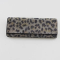 Macro shot of rectangular evening clutch featuring leopard pattern rhinestones on white base - Gold Leopard