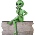 Green alien resin figurine in a sitting pose blowing a kiss with vintage texture - Green Alien Blowing Kiss