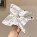 Handmade white scrunchie with red polka dots and a fabric label on a neutral background - White Red Polka Dot Handmade